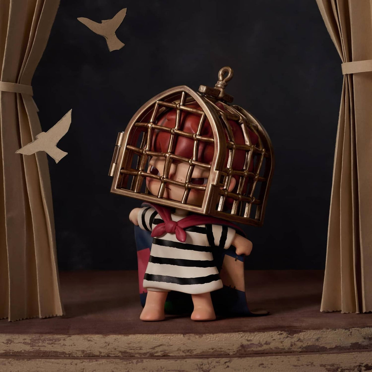Tamed Hirono figure holding a gold cage helmet, wearing a striped shirt and shorts