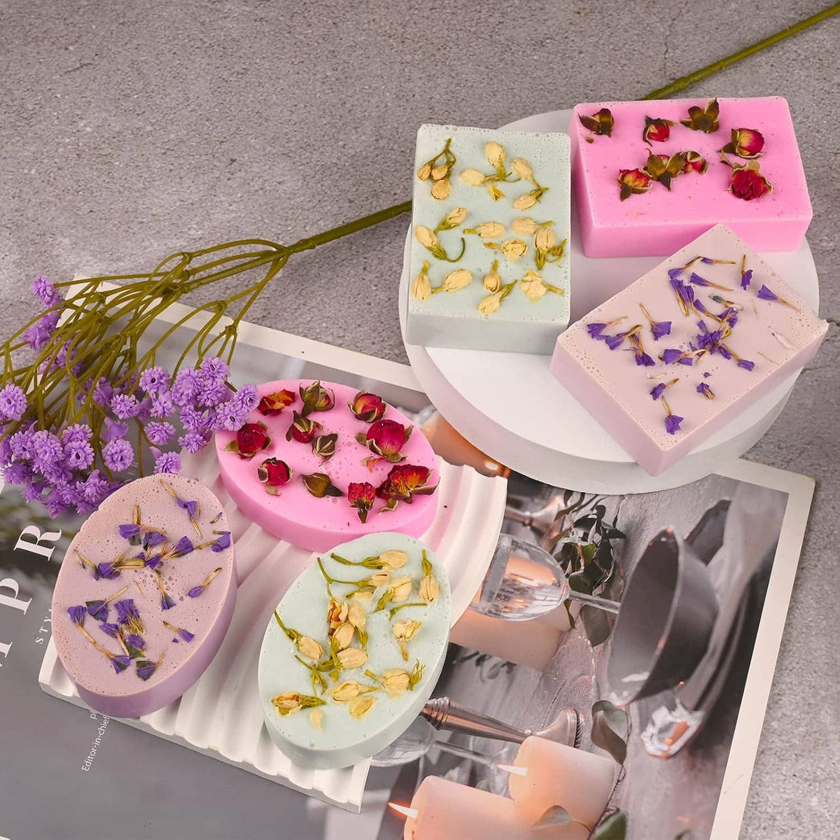 Silicone soap molds with oval and rectangle cavities; soaps with dried flowers on display