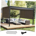 Outdoor pergola shade cover in dark brown fabric with black support posts over patio set