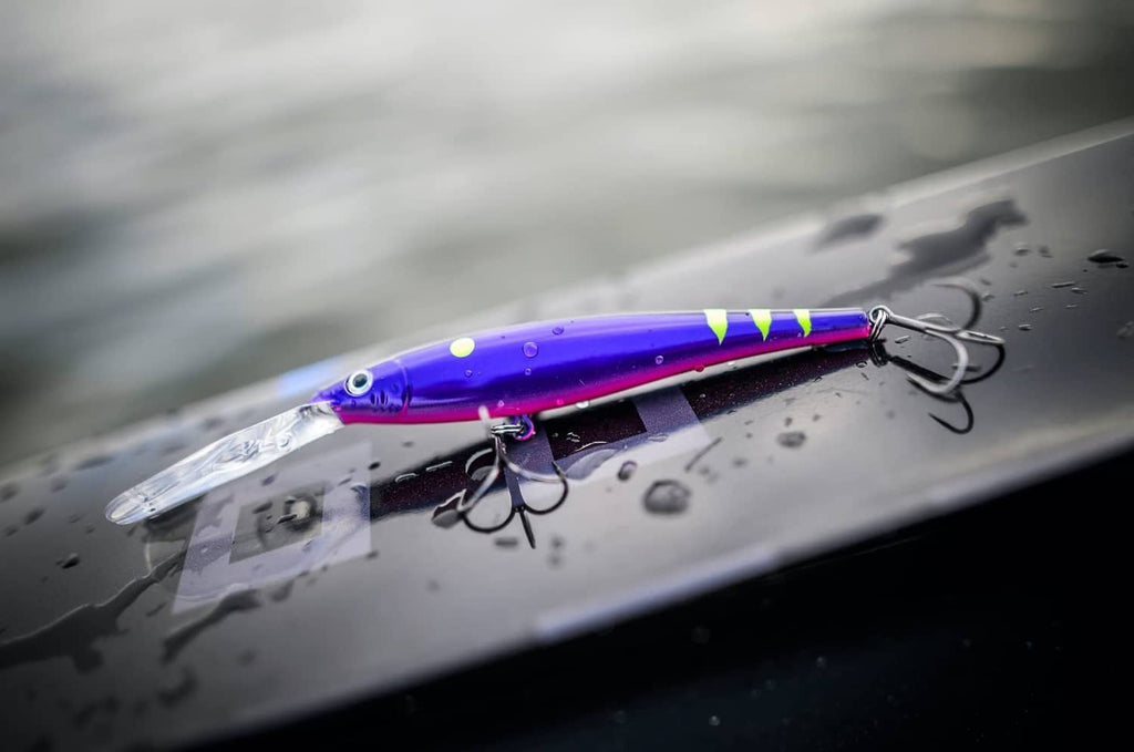 Purple crankbait lure with multicolor stripe, visible lip and treble hooks