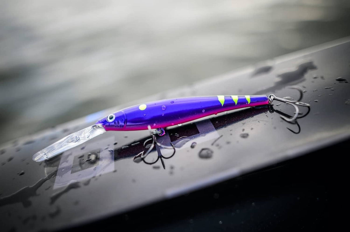 Purple crankbait lure with multicolor stripe, visible lip and treble hooks