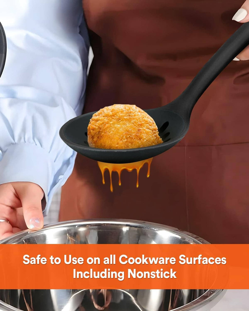 Black perforated ladle strainer with wood handle, draining food over a pot