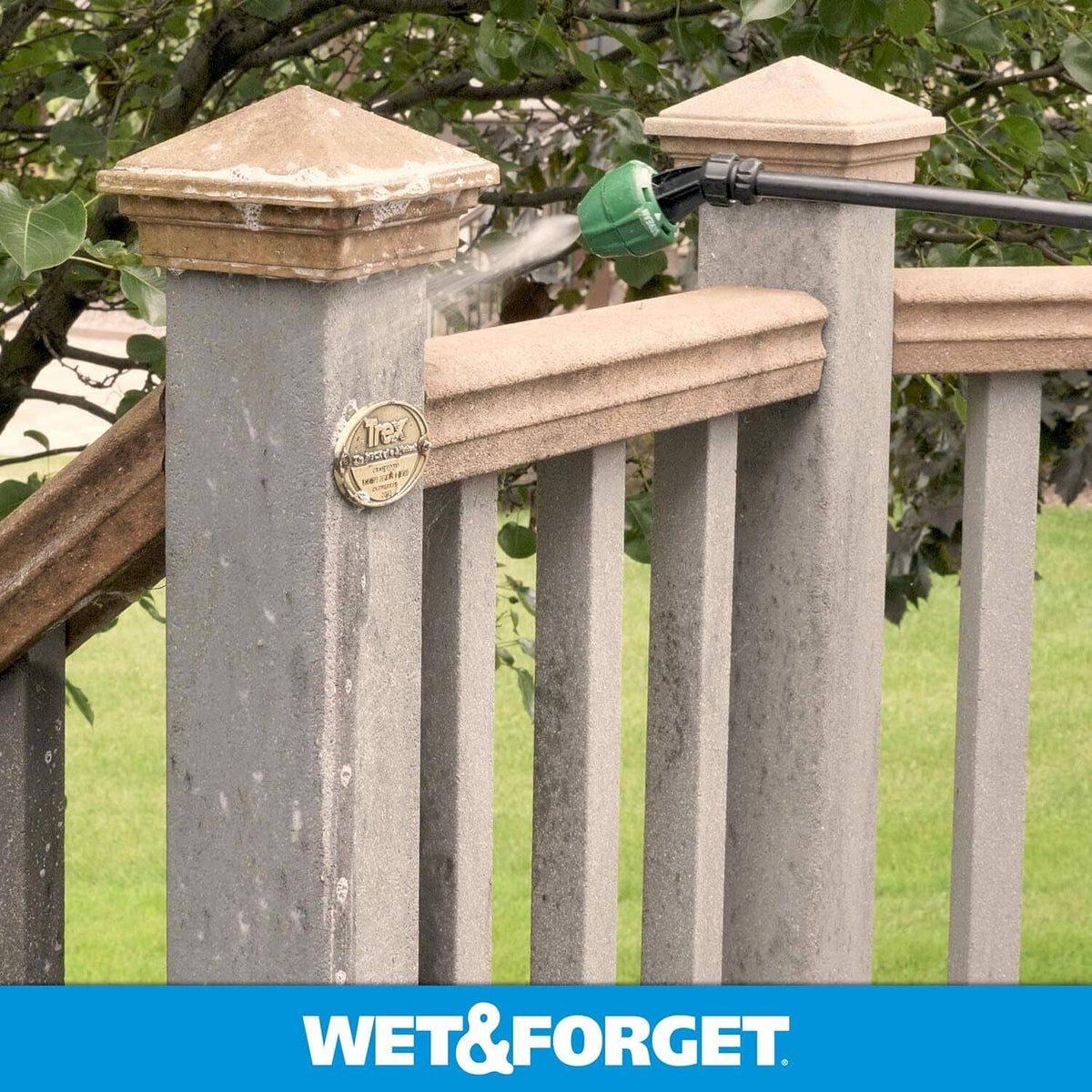 Fence railing and post tops with green algae staining, sprayer directed at surface