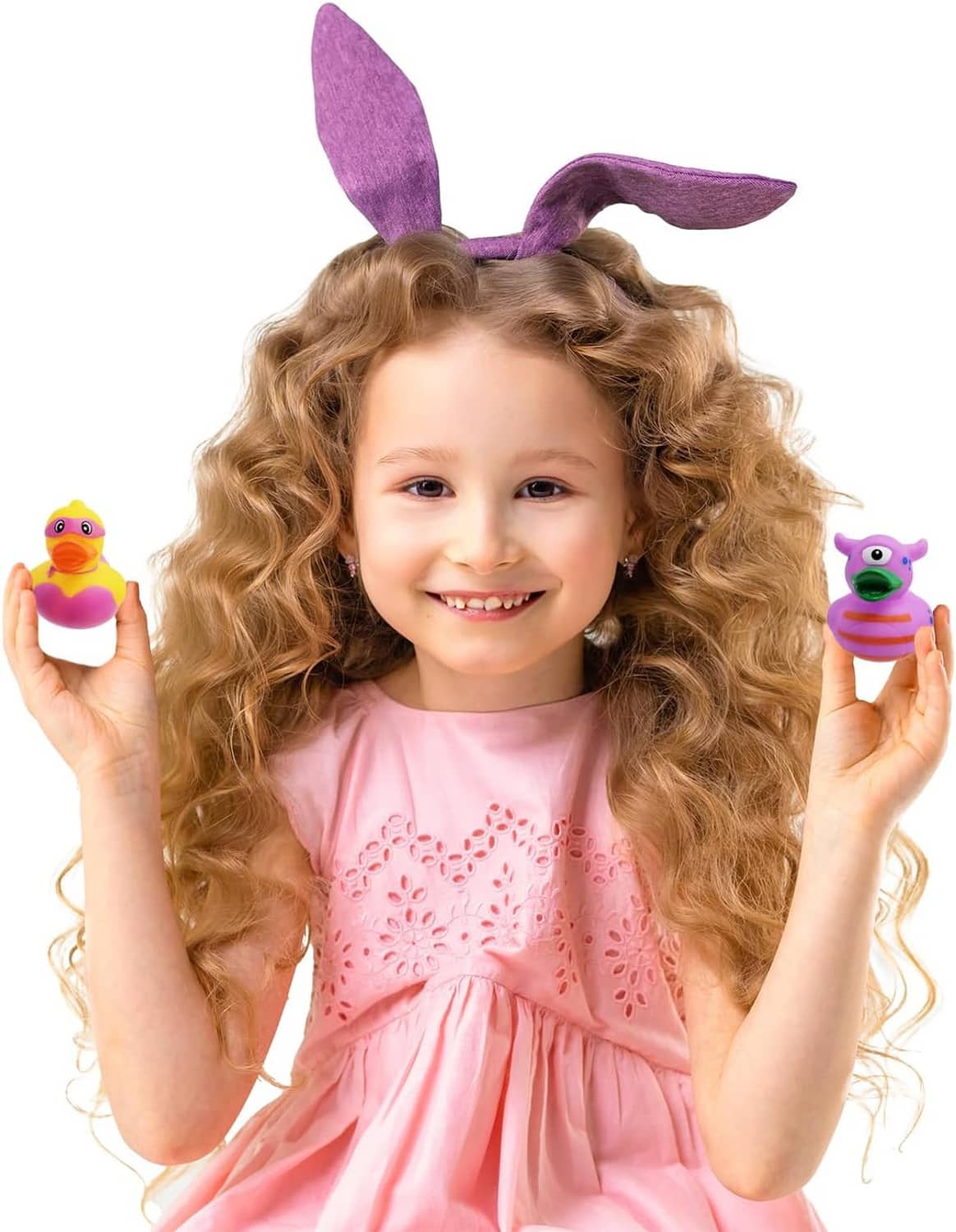 Kids rubber duck bath toy set; child holds two assorted ducks, purple and green designs