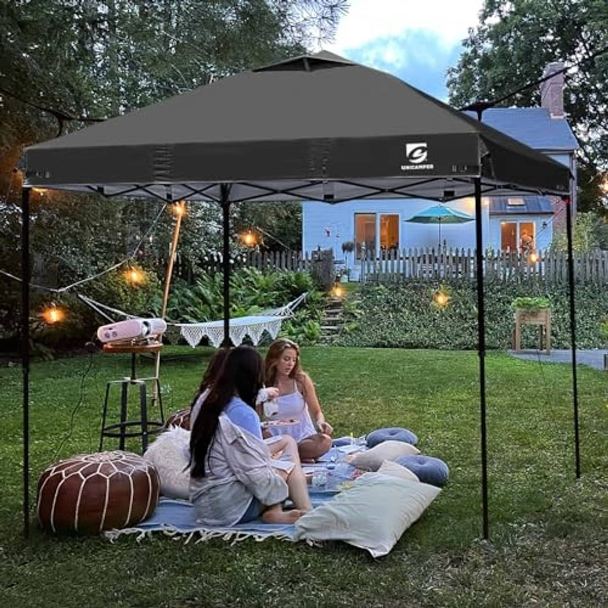Black pop up canopy top cover with vent panel in outdoor backyard setup