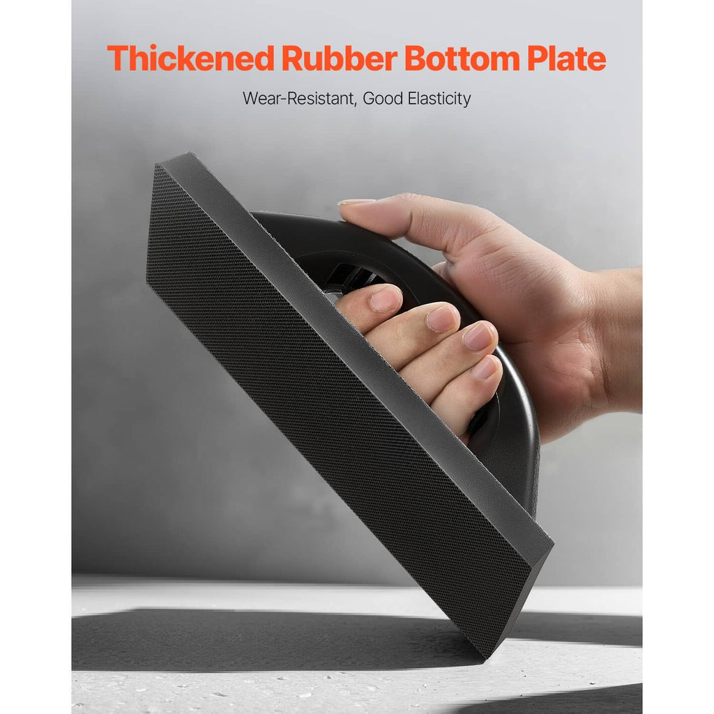 Black grout float with textured rubber base; non-slip grip handle shown in hand