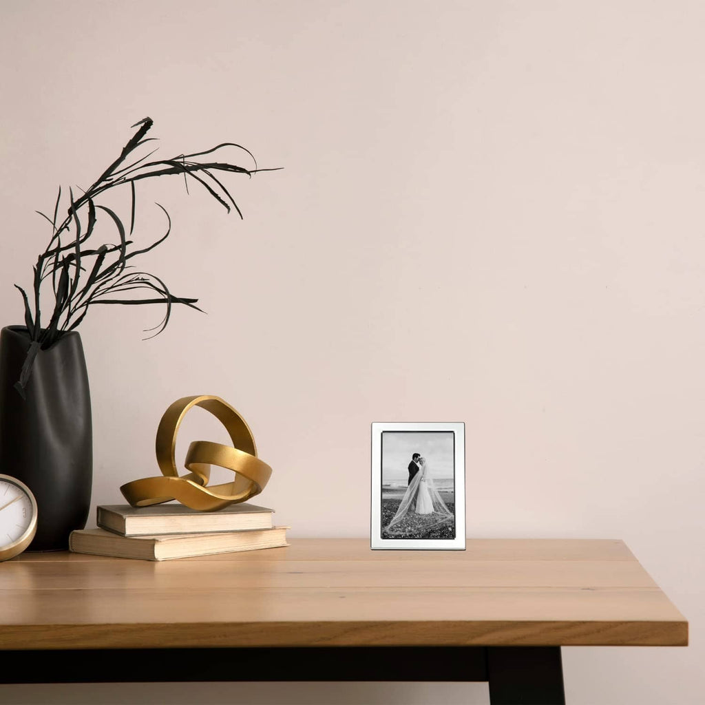 Silver-plated 4x6 picture frame holding a black-and-white photo on tabletop