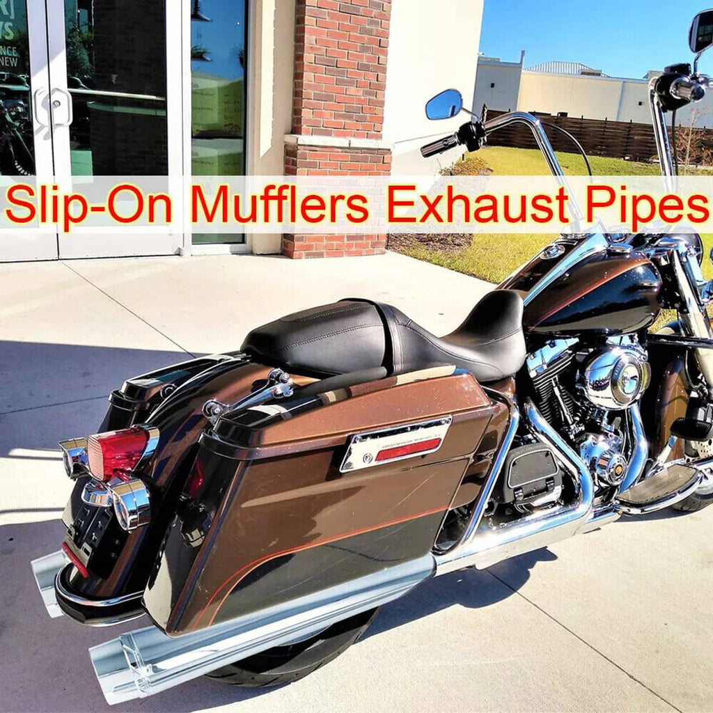 Chrome slip-on mufflers installed on a touring motorcycle, dual cylindrical exhaust pipes