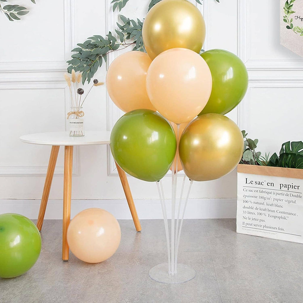 Transparent balloon stand with round base holding green, gold, and peach balloons