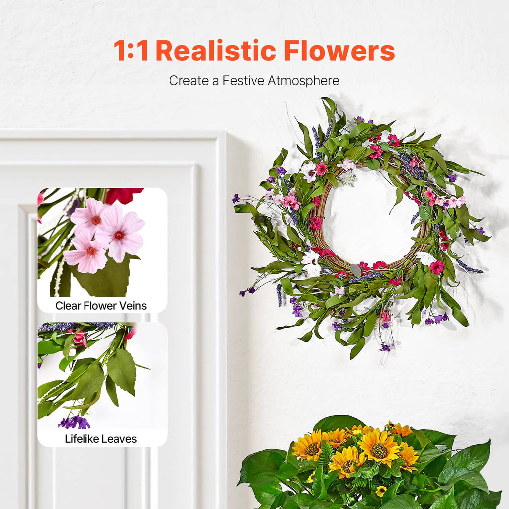 Artificial pink and purple daisy wreath with green foliage on a woven ring