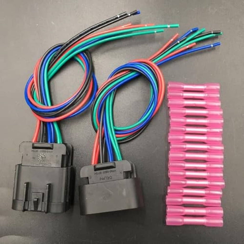 Two black wiring connectors with multicolor wires and pink terminal splice sleeves