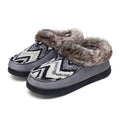 Grey moccasin house shoes with plush faux-fur cuff and zigzag stripe upper, black sole.