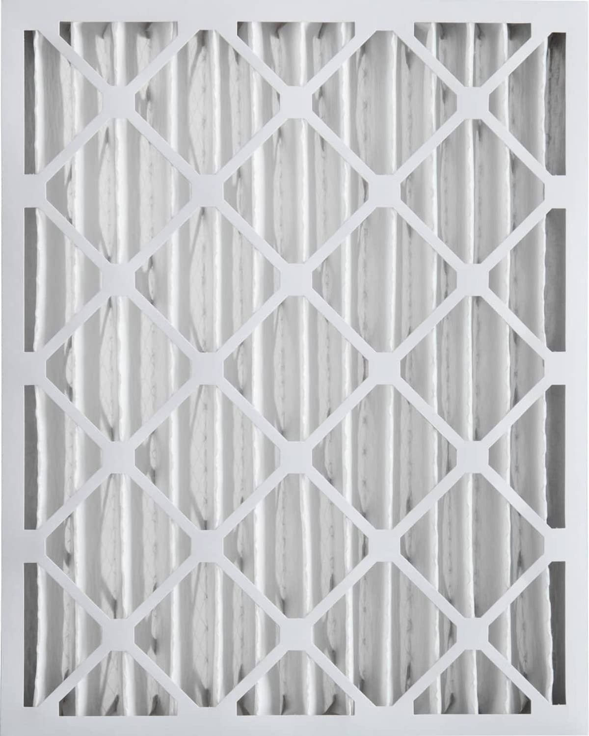 Close-up of pleated white air filter media with diamond-pattern support grid