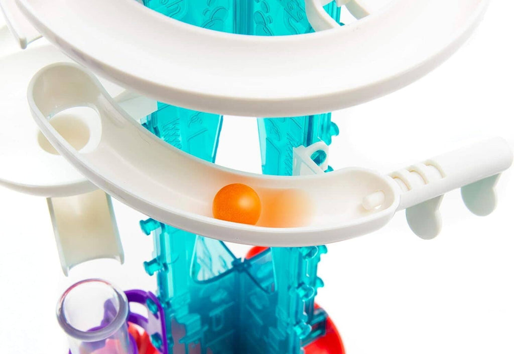White bubble gum machine track with orange ball, side view of chutes and rails