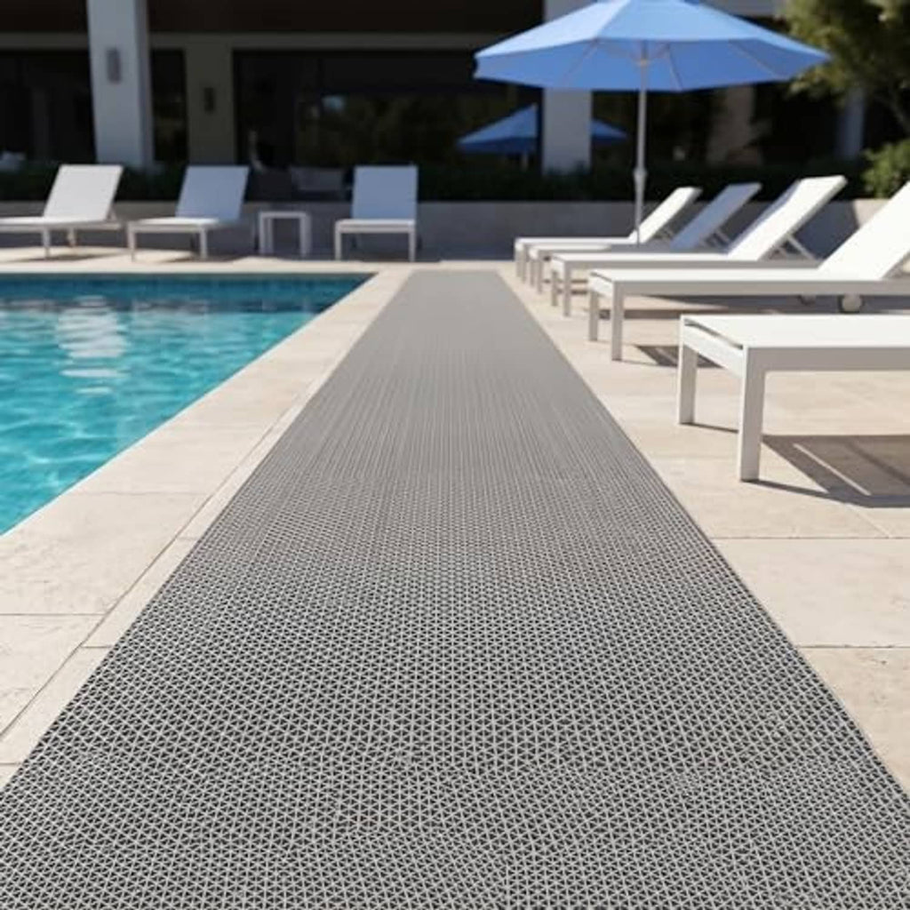 Gray drainage flooring mat runner laid on outdoor pool deck