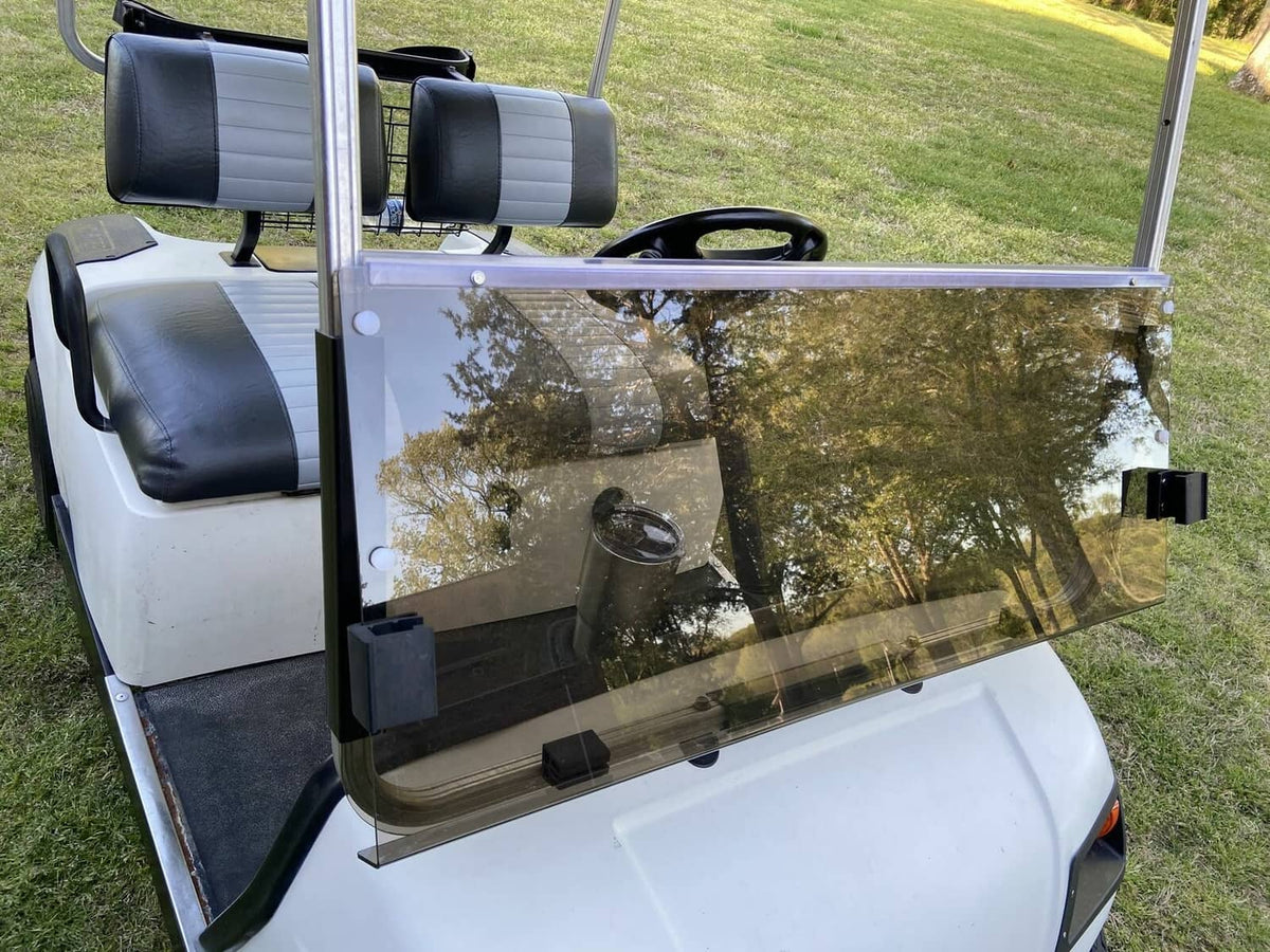 Tinted folding golf cart windshield installed, smoky clear panel with frame posts