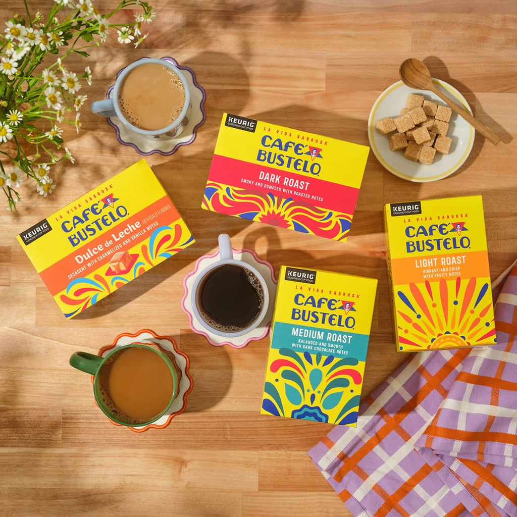 Cafe Bustelo roast variety coffee pods and cups arranged on a wooden table