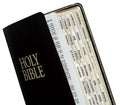 Gold-edged Bible indexing tabs peeking from Holy Bible cover