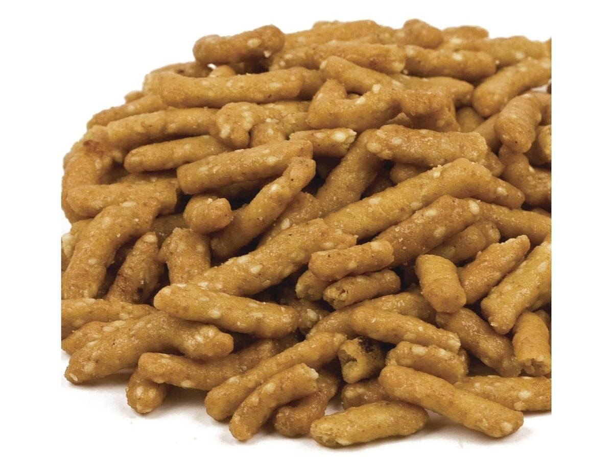 Honey roasted sesame sticks pile, close-up view