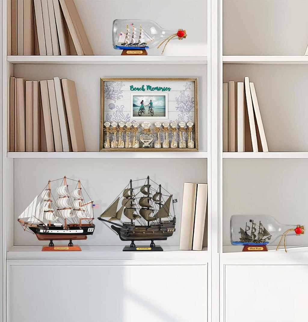 Wooden ship models displayed on shelf with miniature sailboats on stands