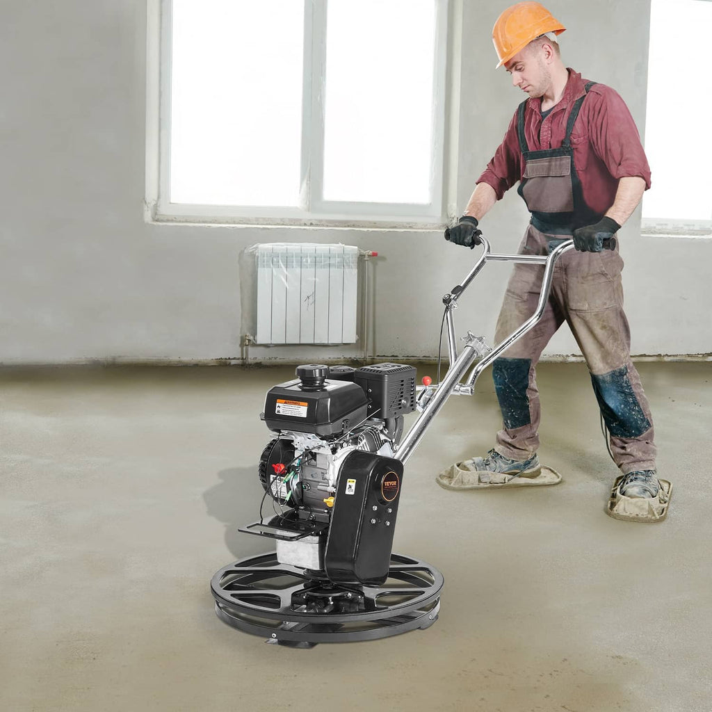 Contractor operating a walk-behind power trowel on a concrete slab, with rotating float disk