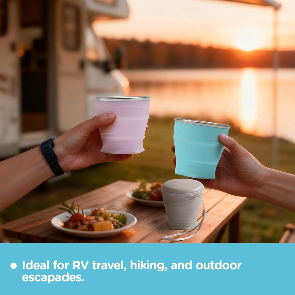 Collapsible silicone cups with lids, pink and teal, held above outdoor table
