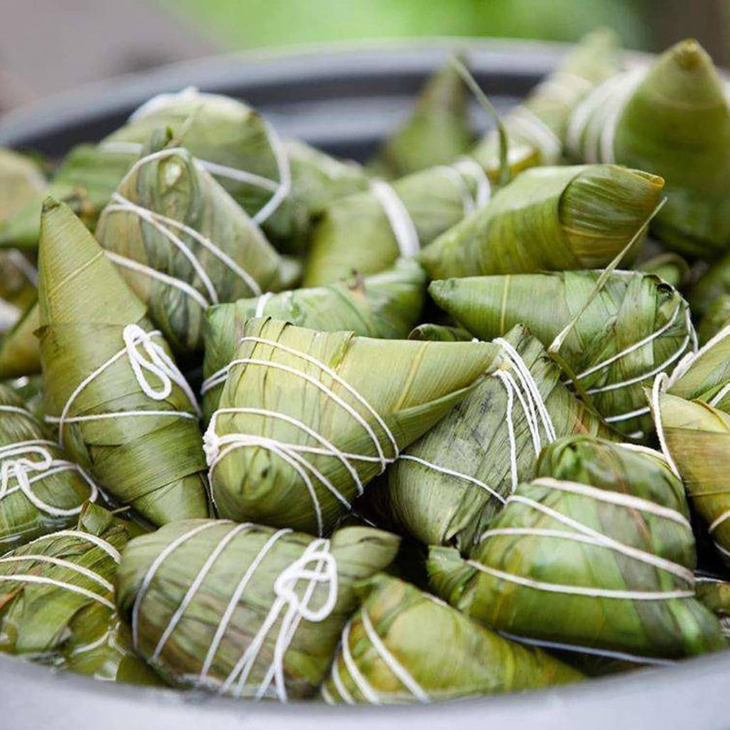 Green produce wrapped and tied with white cotton twine bundles