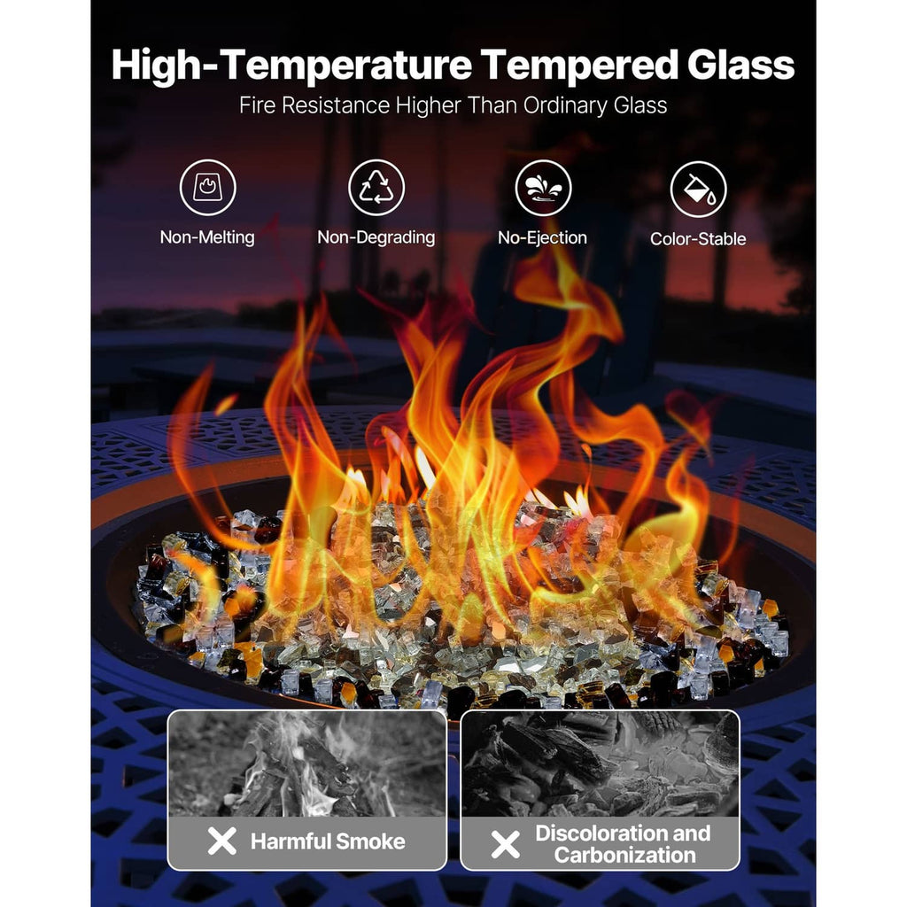Round fire pit with high flames and mixed clear, copper, and gold glass rocks