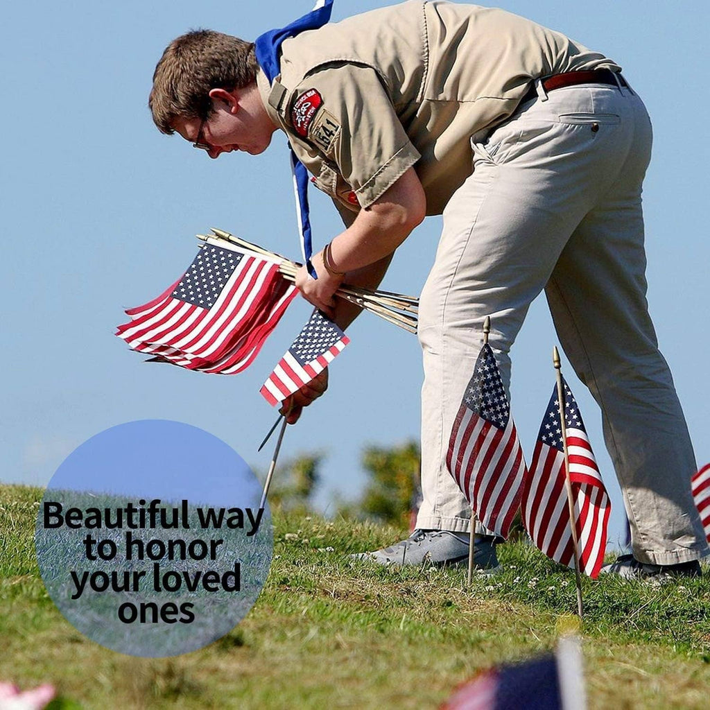 Small American flag lawn flag on wooden stake, red stripes and blue stars for outdoor memorial