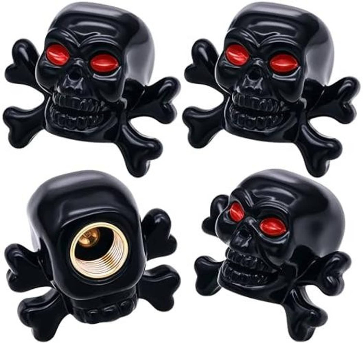 Four black skull tire valve stem caps with red eyes and visible brass valve openings