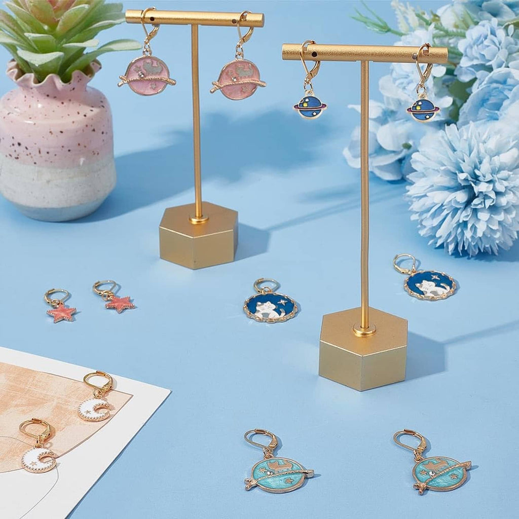 Planet stitch markers displayed on jewelry stand, blue and pink planet and star charms