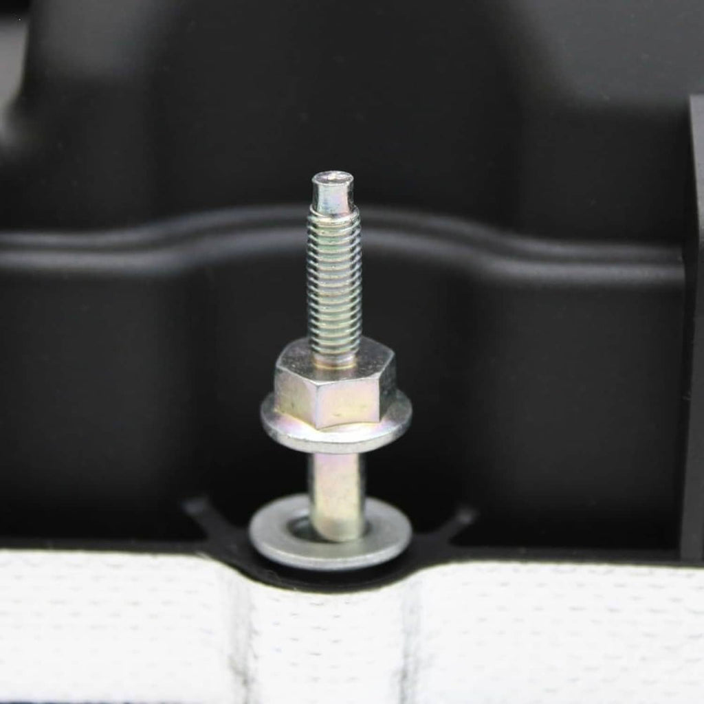 Valve cover gasket mounting stud with nut and washer on the black engine cover