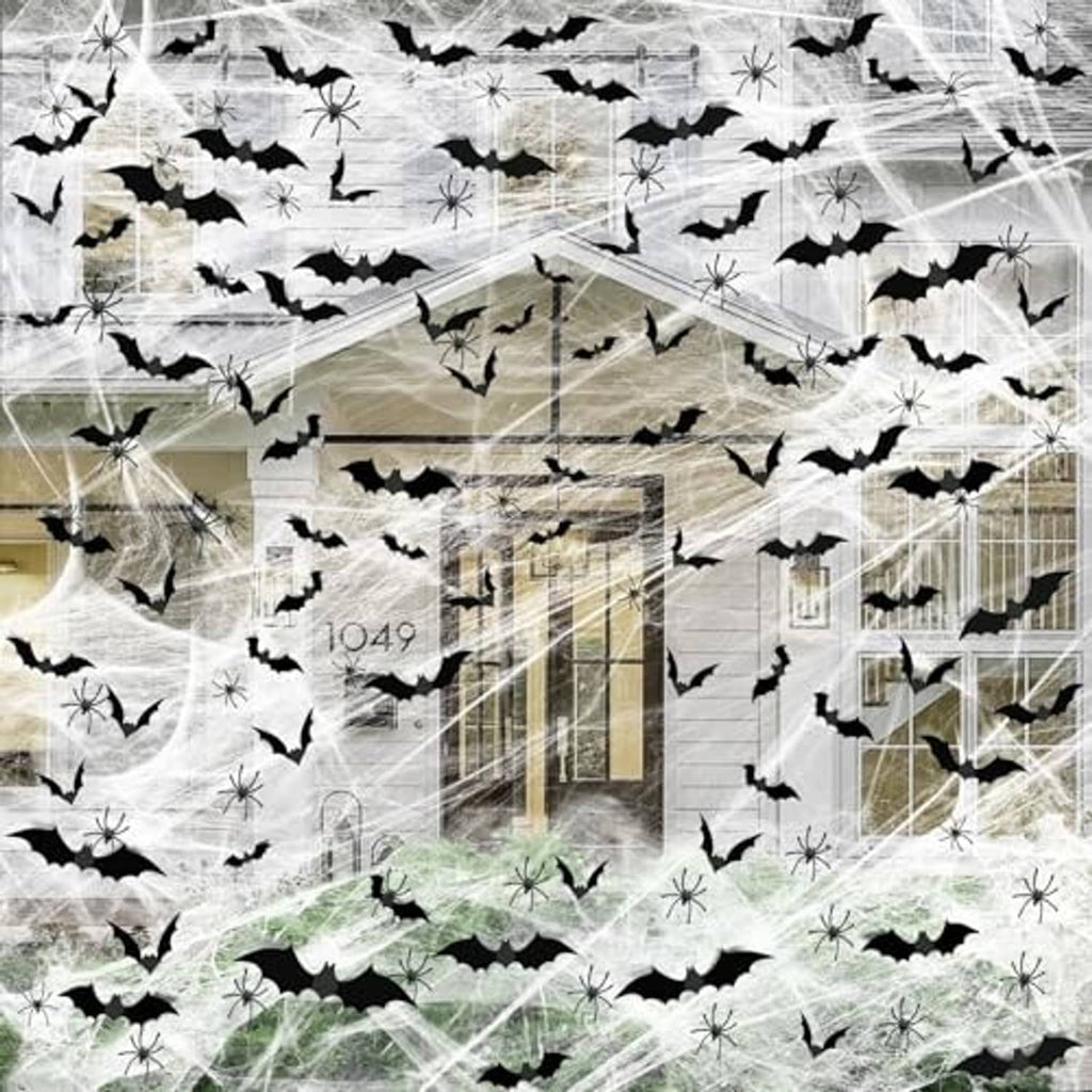 Halloween spider web decoration covering a wall with black bat shapes and web strands