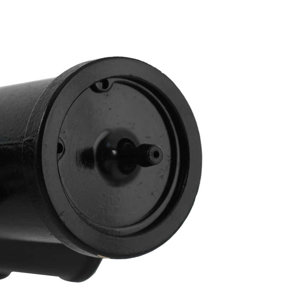 Close-up of black circular pump port with central shaft and mounting face