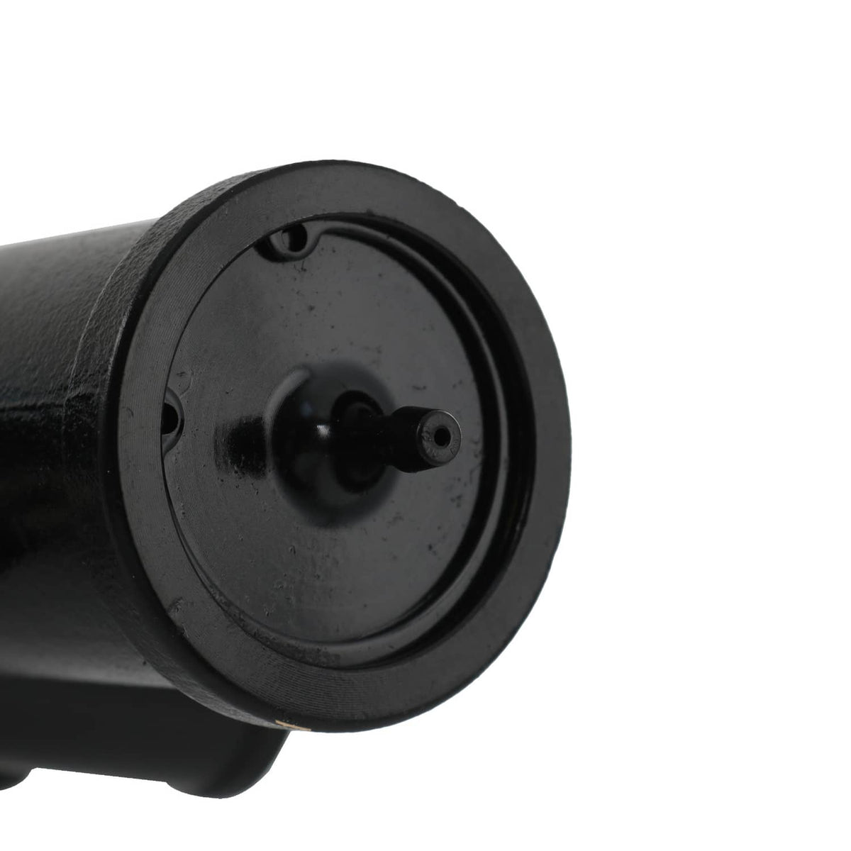 Close-up of black circular pump port with central shaft and mounting face