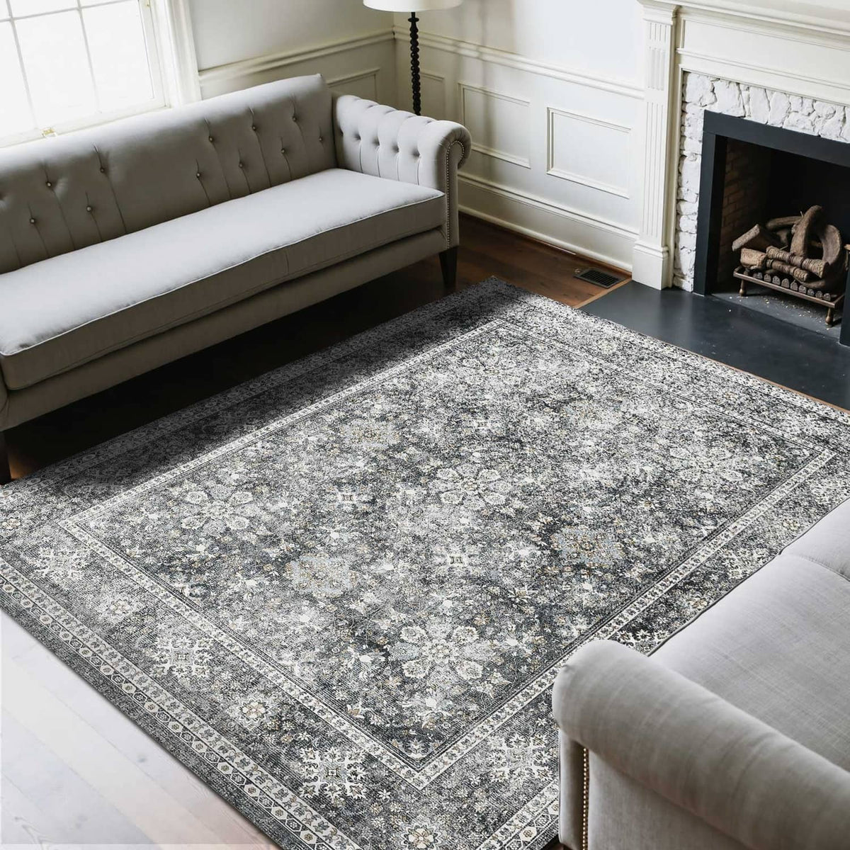 Gray vintage area rug with distressed floral medallion pattern and decorative border