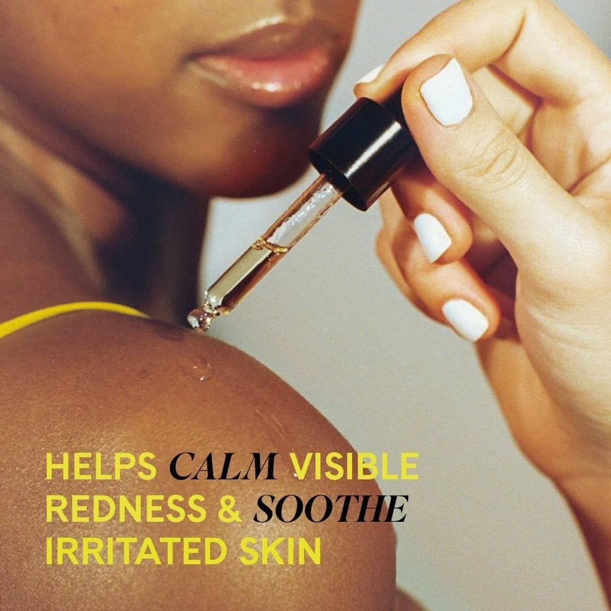 Fur Oil dropper applying golden oil to skin, close-up