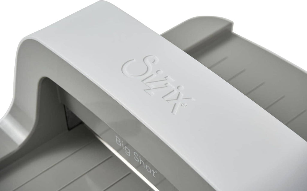 Close-up of Sizzix Big Shot top embossing plate with raised branding