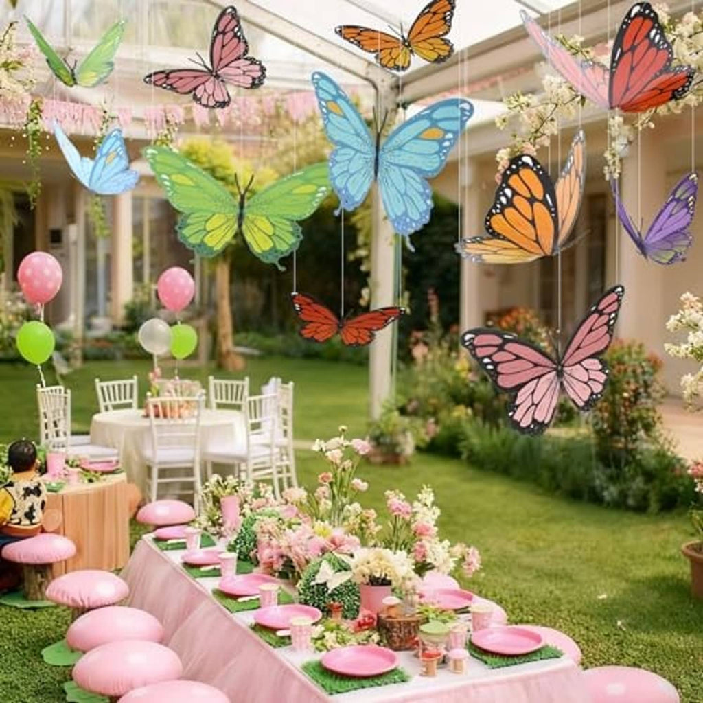 Colorful 3D paper butterflies floating above outdoor party table and chairs