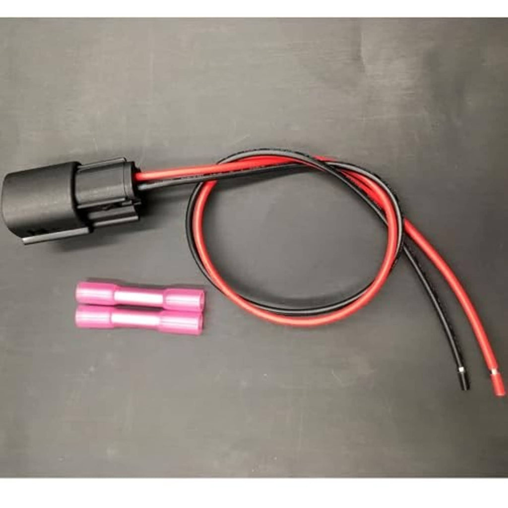 Fog light wiring harness with black plug, red/black wires, and two pink terminal sleeves