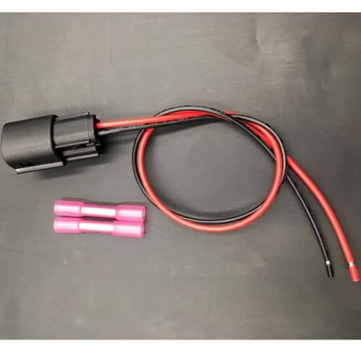 Fog light wiring harness with black plug, red/black wires, and two pink terminal sleeves