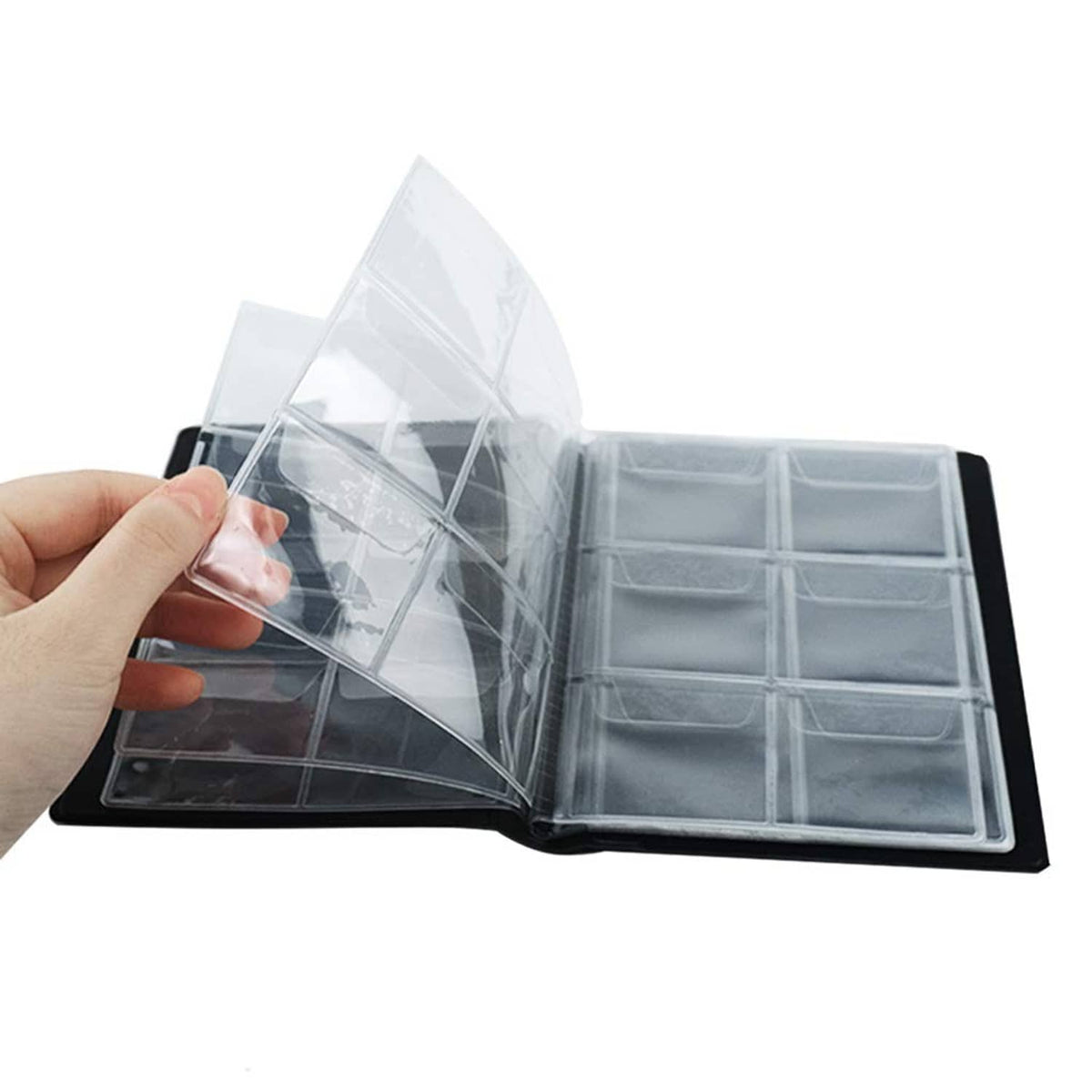Open black coin collection album with multiple clear pockets visible