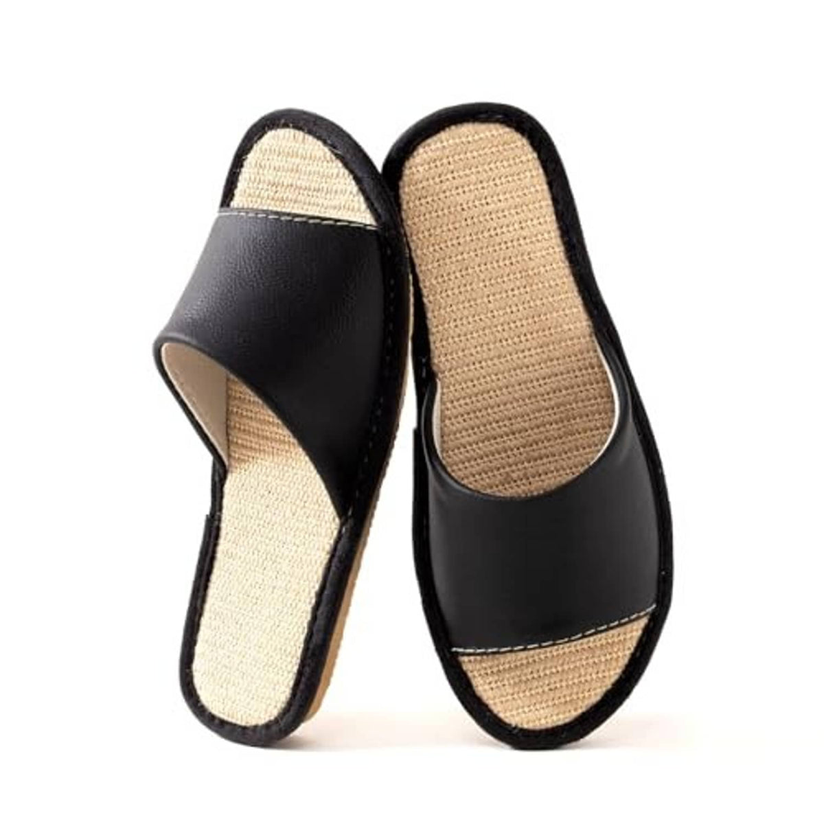 Black leather slip-on house slippers with beige woven insoles and open-back style.