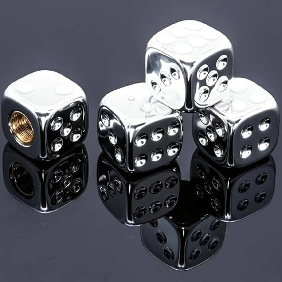 Silver chrome dice-shaped tire valve stem caps, glossy faces with black reflections