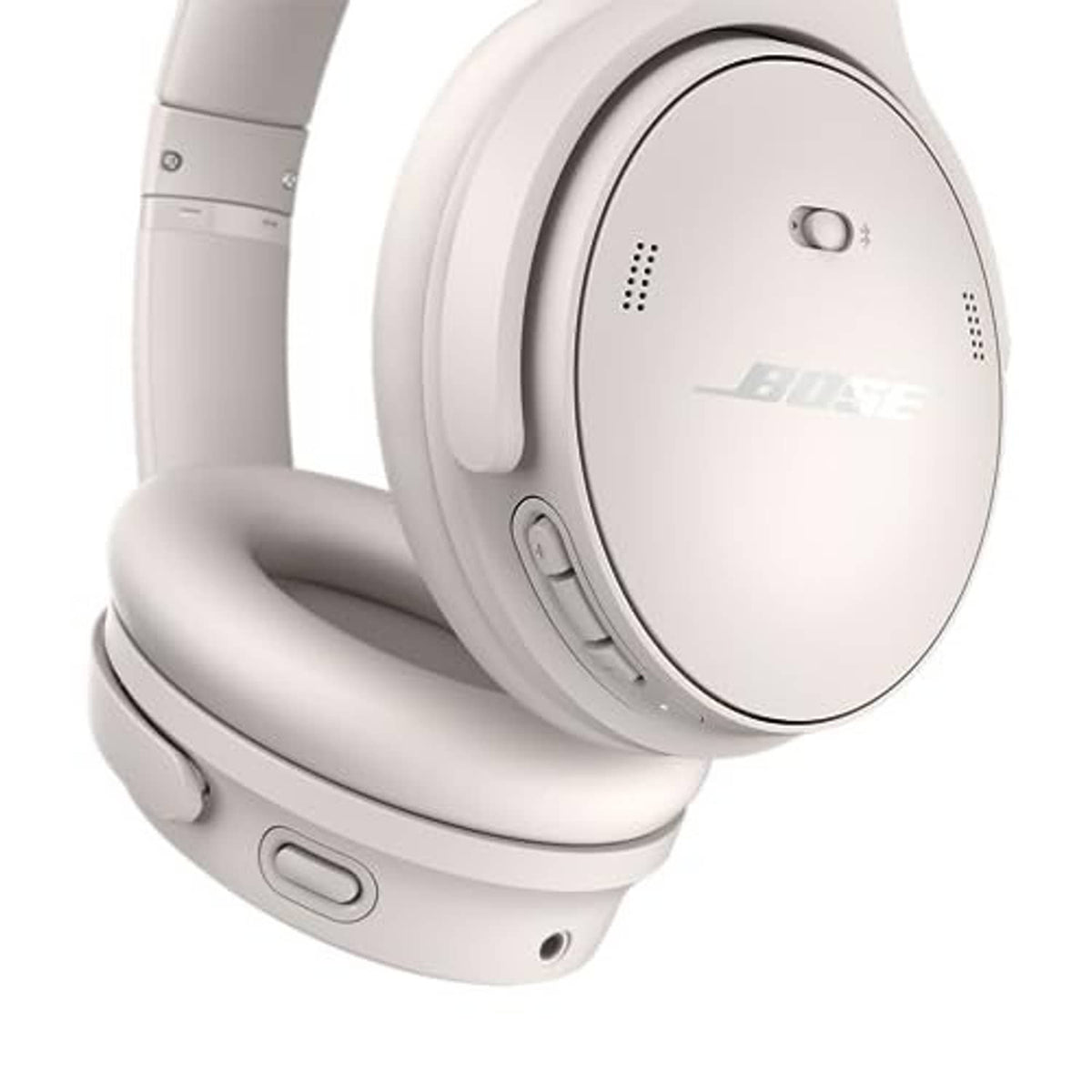 White smoke over-ear headphones showing control buttons and speaker grille on ear cup