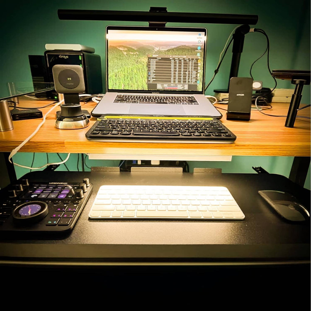 USB-powered LED strip light bar turned on beneath a desk, warm glow
