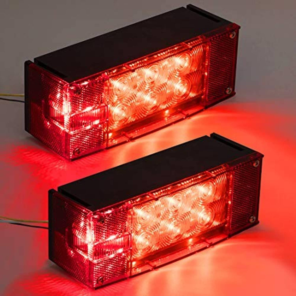 Two illuminated red rectangular LED trailer tail/stop lights with black mounting base