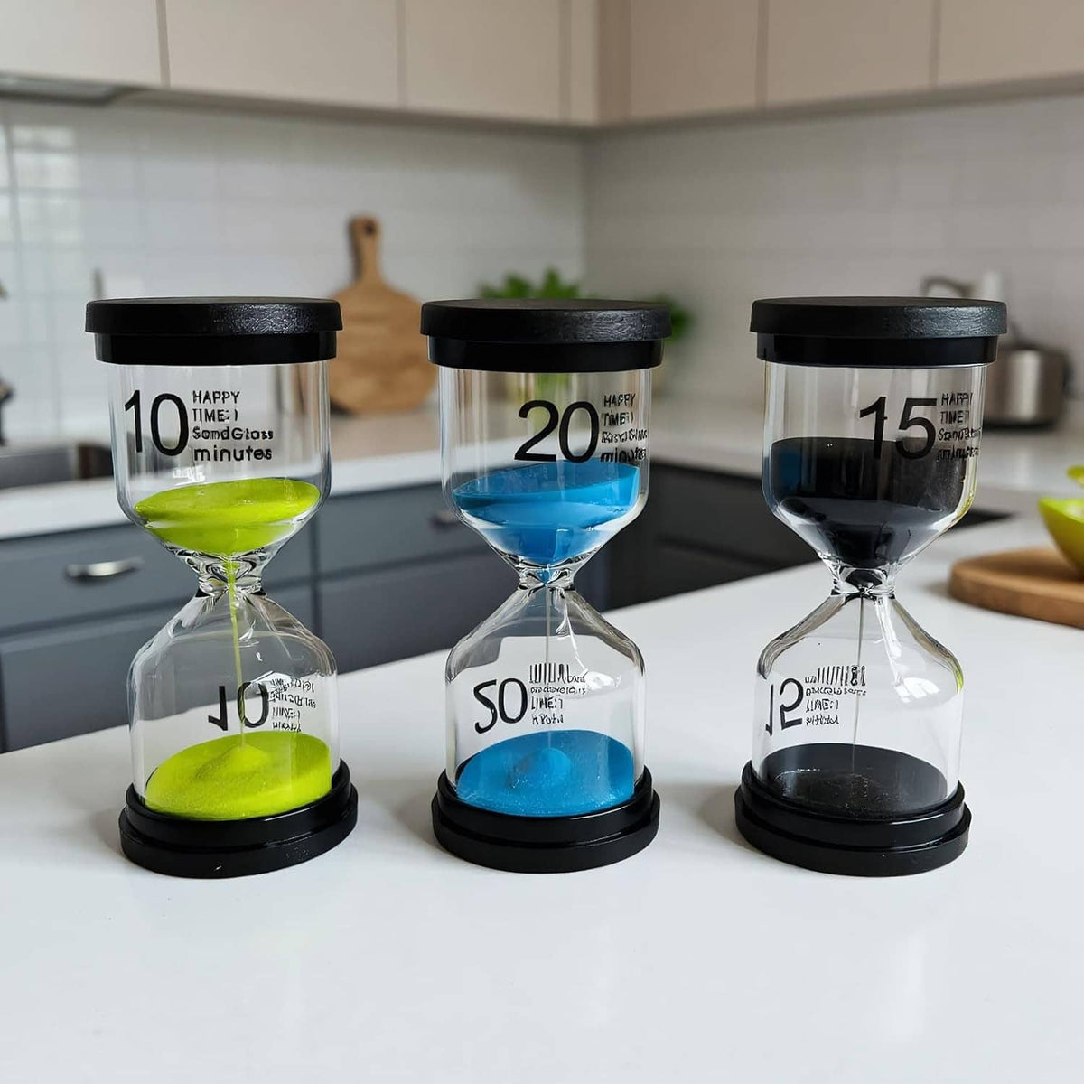 Set of small glass sand timers with blue, green, and black bases
