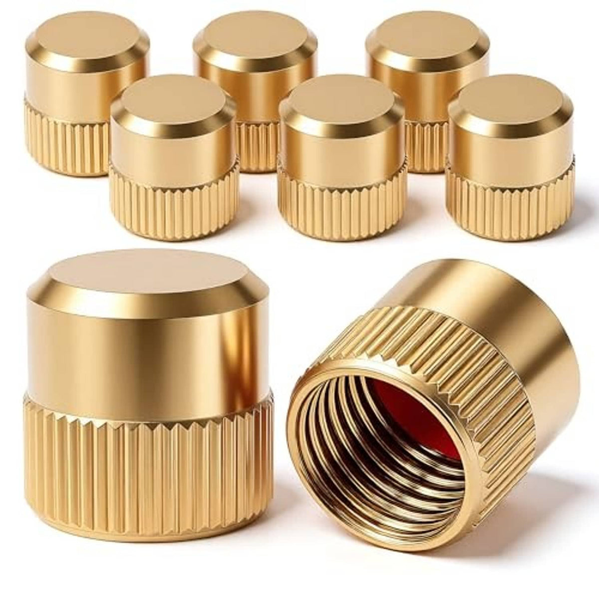 Set of gold valve stem caps with red inner seal, including one close open view.