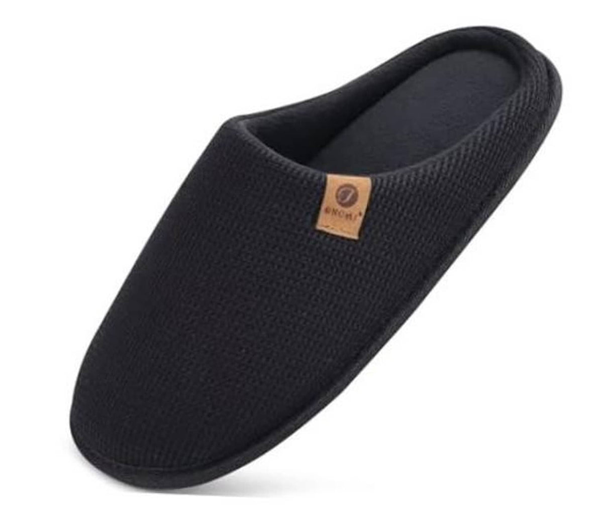 Black slip-on house slipper with textured waffle knit upper and padded collar.